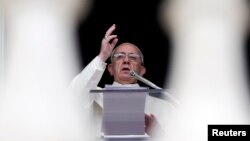 Pope Francis blesses as he leads the Angelus prayer from the window of the Apostolic palace in Saint Peter's Square at the Vatican, Jan. 5, 2014.