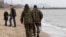 While most of the unrest between Ukrainian forces and pro-Russian separatists are concentrated in the rebel-held areas of Donetsk, local volunteers patrol the city beach in Mariupol, Donetsk region of Ukraine, March 14, 2015. 