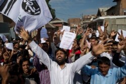 Kashmiri Muslims shout slogans during a protest after Eid prayers in Srinagar, Indian controlled Kashmir, Aug. 12, 2019.