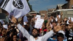 Kashmiri Muslims shout slogans during a protest after Eid prayers in Srinagar, Indian controlled Kashmir, Aug. 12, 2019. 