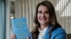 FILE - Melinda Gates displays her new book, "The Moment of Lift," in Kirkland, Wash., April 18, 2019. 