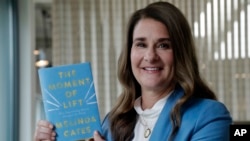 FILE - Melinda Gates displays her new book, "The Moment of Lift," in Kirkland, Wash., April 18, 2019. 