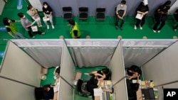 People receive the first dose of the Pfizer-BioNTech COVID-19 coronavirus vaccine at a vaccination center in Seoul, Wednesday, July 28, 2021. South Korea reported a new daily high for coronavirus cases, a day after authorities enforced stringent…