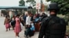 Non-essential United Nations Organization Stabilization Mission in the Democratic Republic of the Congo personnel, along with other U.N. employees, get their belongings inspected by Rwandan security officers as they await evacuation on Jan. 27, 2025