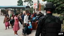 Non-essential United Nations Organization Stabilization Mission in the Democratic Republic of the Congo personnel, along with other U.N. employees, get their belongings inspected by Rwandan security officers as they await evacuation on Jan. 27, 2025