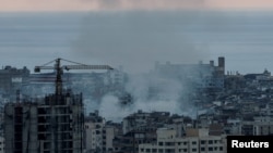 Smoke rises over Dahiyeh in Beirut's southern suburbs after Israeli airstrikes, amid ongoing hostilities between Hezbollah and Israeli forces, as seen from Sin El Fil, Lebanon, Oct. 10, 2024.