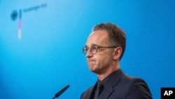 FILE-In this Sept. 2, 2020 file photo German Foreign Minister Heiko Maas attends a press conference at the Foreign Ministry in Berlin, Germany. Germany is increasing pressure on Russia over the poisoning of Russian opposition politician Alexei…