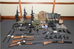 FILE - This photo from the Maryland U.S. District Attorney's Office shows firearms and ammunition from Coast Guard officer Christopher Paul Hasson, accused of stockpiling guns and compiling a hit list of Democrats and network TV journalists.