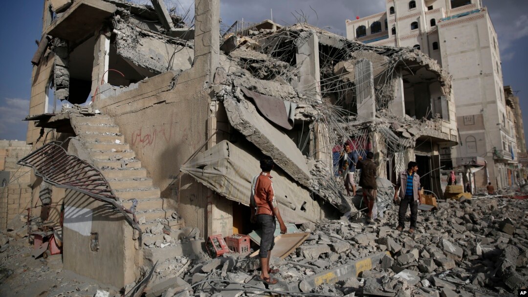 FILE - Yemeni men inspect a house destroyed by a Saudi-led airstrike in Sanaa, Yemen, Monday, Jan. 25, 2016. 