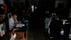 A vendor works at his flea market without power during a blackout in several neighborhoods in Sao Paulo, Brazil, on Oct. 12, 2024. 