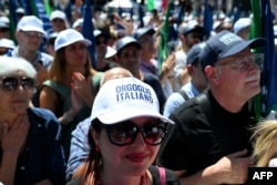 Supporters of Italian Prime Minister Giorgia Meloni attend a campaign meeting of Italian far-right party Brothers of Italy for the upcoming European elections, on June 1, 2024, in Rome.