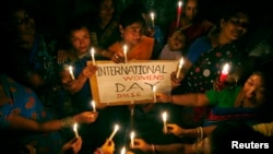 FILE - Sex workers hold candles during a rally to mark International Women's Day inside a brothel in the northeastern Indian city of Siliguri, March 8, 2008.