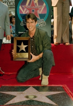 Actor Tom Cruise poses with his new star on the Hollywood Walk of Fame on Hollywood Boulevard, Oct. 16, 1986.