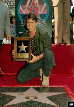 Actor Tom Cruise poses with his new star on the Hollywood Walk of Fame on Hollywood Boulevard, Oct. 16, 1986.
