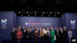 FILE - Britain's Michelle Donelan, Secretary of State for Science, Innovation and Technology, 6th right front row, with Digital Ministers who are attending the AI Saftey Summit in Bletchley Park, Milton Keynes, England, Wednesday, Nov. 1, 2023. 