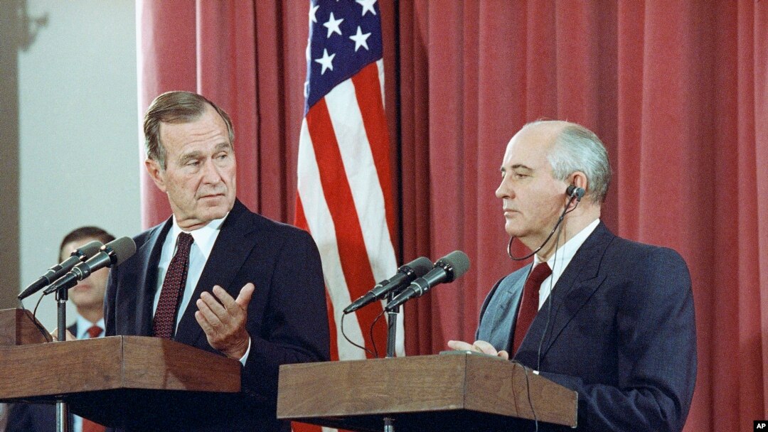 FILE - President George H.W. Bush gestures during a joint news conference with Soviet President Mikhail Gorbachev, at the Soviet Embassy in Madrid, Oct. 29, 1991. Bush died at the age of 94 on Friday, Nov. 30, 2018.