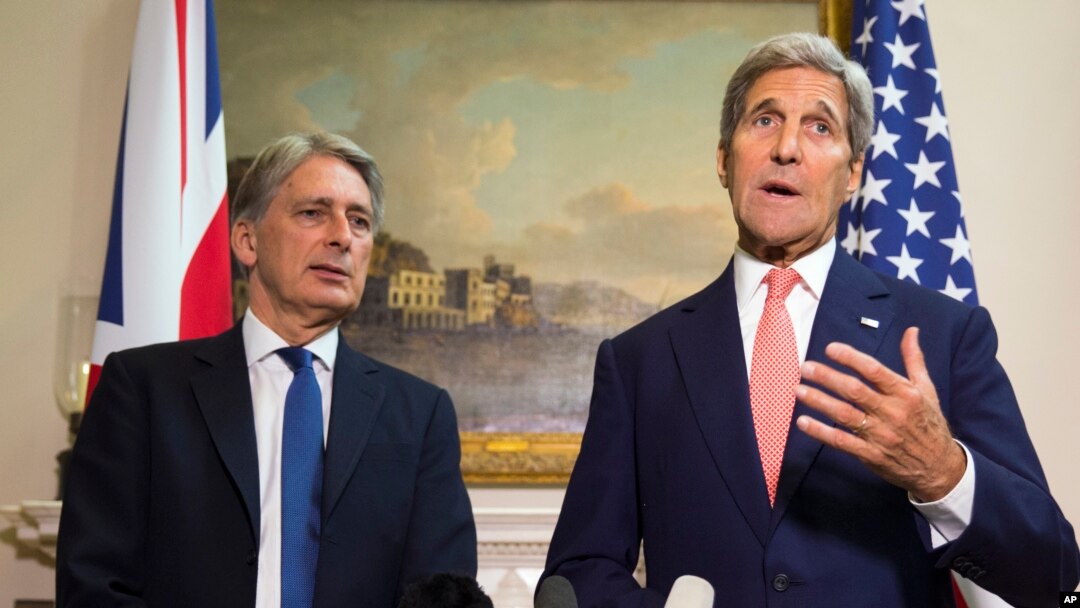 U.S. Secretary of State John Kerry, right, answers a question about the crisis in Syria during a news conference with British Foreign Secretary Philip Hammond in London, Sept. 19, 2015. 