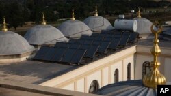 Solar panels work on the roof of the Nizamiye Mosque in Johannesburg, South Africa, April 5, 2023.