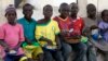 Children displaced as a result of Boko Haram attacks in the northeast region of Nigeria, eat their meal at a camp for internally displaced persons (IDP) in Yola, Adamawa State, Jan. 13, 2015. 