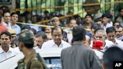 Indian Home Minister P. Chidambaram (C), wearing glasses, leaves after inspecting the site of a blast outside the High Court in New Delhi, India, September 7, 2011.