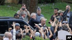 Lula da Silva, vistiendo un traje oscuro, sin corbata y con el cabello totalmente blanco, fue trasladado en medio de un intenso dispositivo de seguridad, y escoltado de cerca por tres agentes de la Policía Federal.