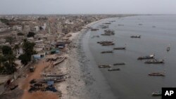 FILE - Traditional boats, known as pirogues, are docked at the Yarakh Beach littered by trash and plastics in Dakar, Senegal, Tuesday, Nov. 8, 2022