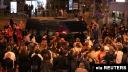 People surround a police van during an opposition protest against the inauguration of Belarusian President Alexander Lukashenko in Minsk, Belarus, Sept. 23, 2020. 