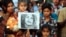 An Indian child poses with a placard as demonstrators participate in a protest in Allahabad, April 23, 2013, following the rape of a five-year old girl in New Delhi.