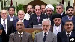 Iraq's Prime Minister Nouri al-Maliki, speaks at a podium surrounded by lawmakers, Aug. 14, 2014. 