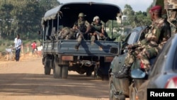 Soldiers patrol the area after an attack in Dabou, around 50 km (30 miles) west of Abidjan, Ivory Coast, Aug. 16, 2012. 