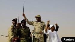 FILE - Lieutenant General Mohamed Hamdan Dagalo, deputy head of the military council and head of paramilitary Rapid Support Forces (RSF), greets his supporters as he arrives at a meeting in Aprag village, 60 kilometers away from Khartoum, Sudan, June 22, 2019.