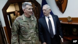 U.S. Defense Secretary James Mattis, right, and U.S. Army General John Nicholson, left, commander of U.S. Forces Afghanistan, arrive to meet with an Afghan defense delegation at Resolute Support headquarters, in Kabul Afghanistan, April 24, 2017. Mattis arrived unannounced in Afghanistan to assess America's longest war as the Trump administration weighs sending more U.S. troops. 