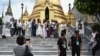 FILE - This picture taken on Sept. 10, 2023 shows Chinese tourists posing for photographs at the Grand Palace in Bangkok. Thailand is concerned about the impact of Myanmar-based scam centers on its tourist market. 