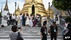 FILE - This picture taken on Sept. 10, 2023 shows Chinese tourists posing for photographs at the Grand Palace in Bangkok. Thailand is concerned about the impact of Myanmar-based scam centers on its tourist market. 