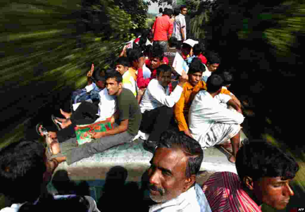 Passengers sit on top of an overcrowded train as it heads for Mymensingh from Dhaka, November 16, 2010. (Andrew Biraj/Reuters)