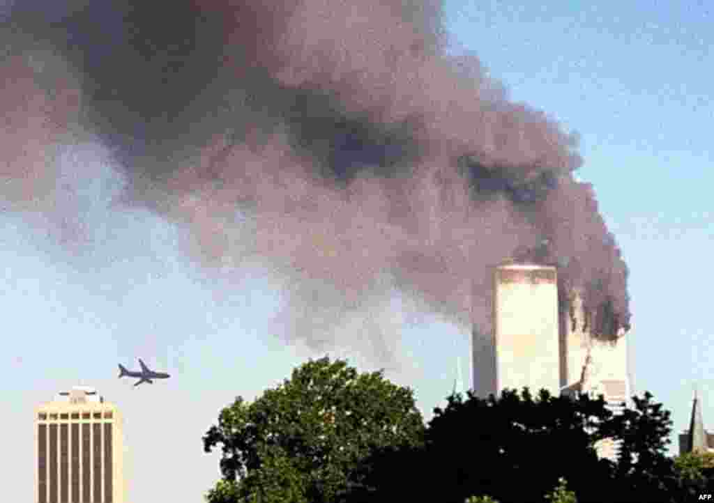 A plane approaches New York's World Trade Center moments before it struck the tower at left, as seen from downtown Brooklyn, Tuesday, Sept. 11, 2001. In an unprecedented show of terrorist horror, the 110 story towers collapsed in a shower of rubble and du