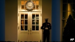 A Marine guard stands at the entrance to the West Wing of the White House, after the U.S. House impeached President Donald Trump in Washington, Wednesday, Jan. 13, 2021. The guard's presence signifies the president is in the Oval Office.