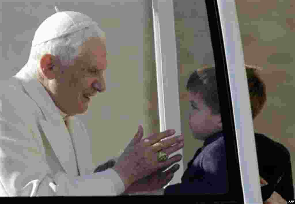 Pope Benedict XVI greets a child during his weekly general audience, in St. Peter square, at the Vatican, Wednesday, Nov. 17, 2010. (AP Photo/Alessandra Tarantino)