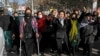 FILE — Afghans protest the ban on university education for women, in Kabul, Afghanistan, Dec. 22, 2022. Four female students say their visa applications to the U.S. and Canadian embassies in Islamabad were denied, despite each presenting fully funded scholarship awards. 