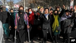 FILE — Afghans protest the ban on university education for women, in Kabul, Afghanistan, Dec. 22, 2022. Four female students say their visa applications to the U.S. and Canadian embassies in Islamabad were denied, despite each presenting fully funded scholarship awards. 