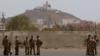 FILE - Members of a French military flight crew talk on the tarmac at France's military air base in Dakar, Senegal, on June 2, 2009. Senegal announced on Dec. 27, 2024, the closure of all foreign military bases.