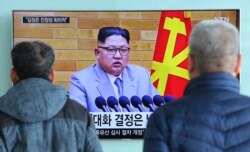 FILE - People watch a TV screen showing North Korean leader Kim Jong Un's New Year's speech, at Seoul Railway Station in Seoul, South Korea, Jan. 3, 2018. North and South Korea agreed Friday to revive their formal dialogue.