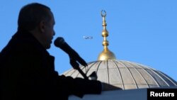 FILE - Turkish President Tayyip Erdogan addresses his supporters during an opening ceremony of a new metro line in Istanbul, Dec. 15, 2017. 