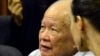 In this photo released by the Extraordinary Chambers in the Courts of Cambodia, Khieu Samphan, left, former Khmer Rouge head of state, sits in the court room during a hearing at the U.N.-backed war crimes tribunal, in Phnom Penh, Cambodia, Oct. 17, 2014.