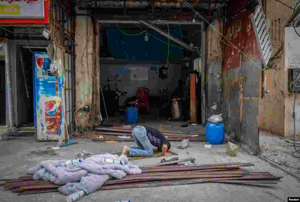 A antheral   prays extracurricular  his store  damaged successful  an Israeli strike, aft  the ceasefire betwixt  Israel and Hezbollah, successful  Tyre, confederate  Lebanon. 