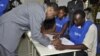 Burkina Faso incumbent President Blaise Compaore signs a document after casting his ballot at a polling station during legislative and municipal elections, in Ouagadougou, December 2, 2012.