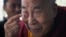 Tibetan spiritual leader the Dalai Lama points to his swollen right eye as he talks to journalists before boarding his chartered flight in Dharmsala, India, Jan. 19, 2016. 