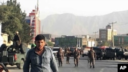 Afghan security police stand guard near the site of a deadly suicide attack outside a cricket stadium, in Kabul, Afghanistan, Sept. 13, 2017. 