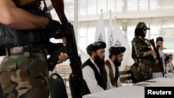 FILE - Afghanistan Taliban officials attend a news conference in Kabul, Afghanistan October 5, 2021. 