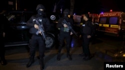 Tunisian police officers stand guard after an attack on a military bus Nov. 24, 2015, in Tunis, Tunisia. 